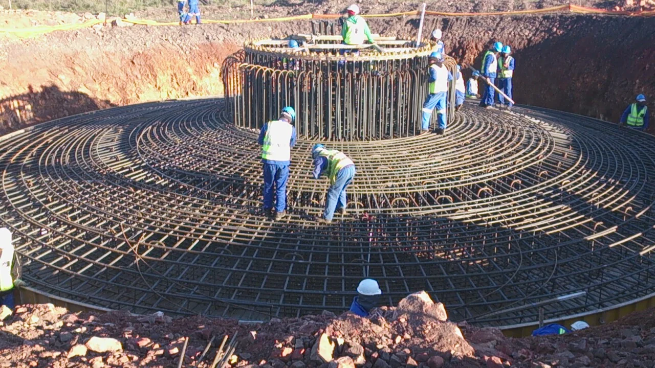 Field team installing earthing on a wind turbine foundation